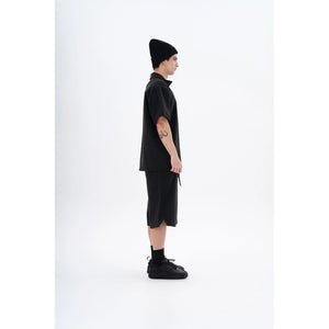 "Side view of the YAD Dark Grey Bermuda Shorts on a male model - Displaying its relaxed fit and contemporary urban style."